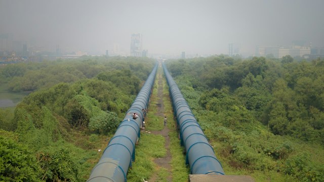 Pipeline running through open terrain toward the horizon