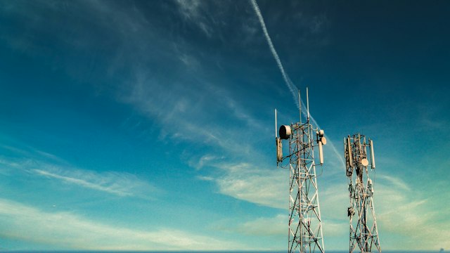 Telecom lattice towers with antenna arrays against the sky