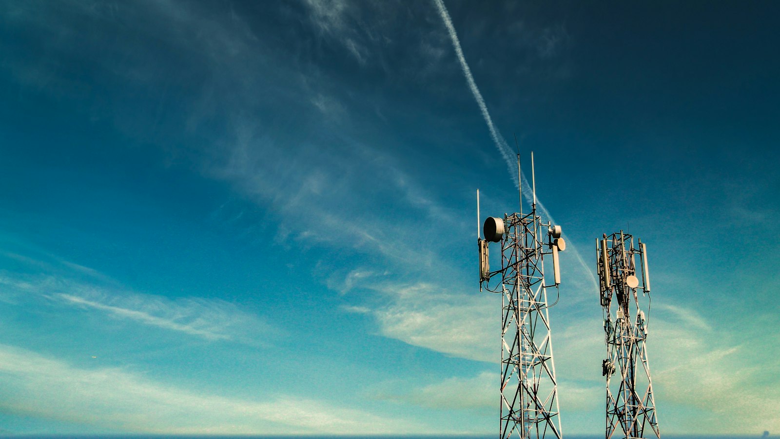 Telecom lattice towers with antenna arrays against the sky
